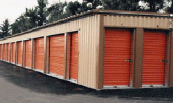 Self storage building exterior with orange doors