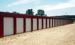 Self storage building exterior with white doors