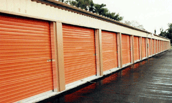 Self storage building exterior with orange doors