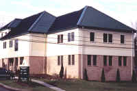 Exterior of office building with black metal roof